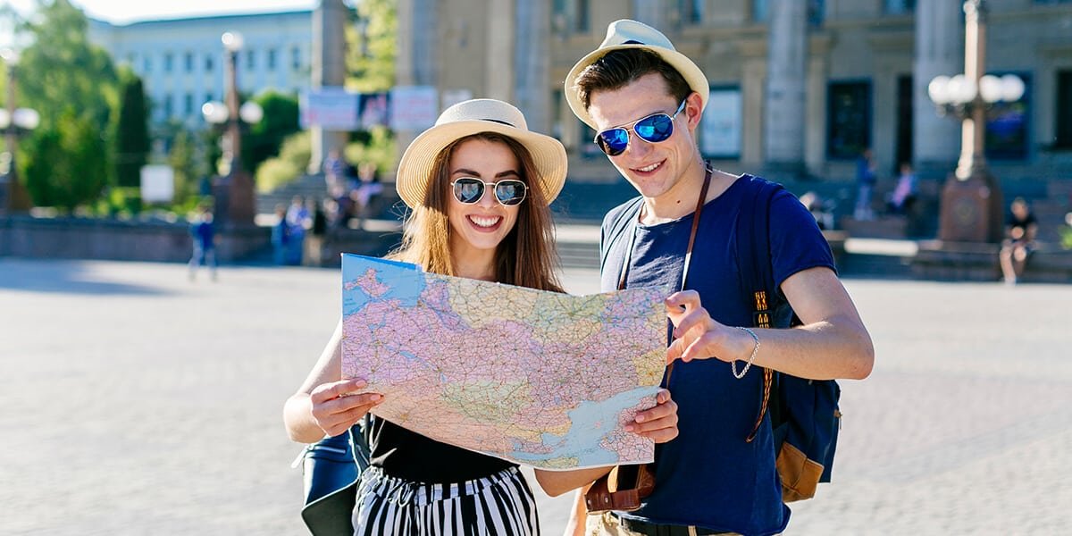 A couple visiting Cuba looking at a map. Navigating the Cuban Non Immigrant Visa Process