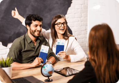 couple with their travel agent showing exitement of getting a visa for cuba
