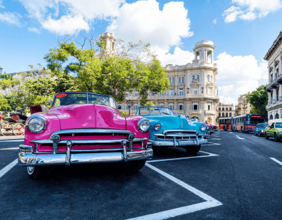 two colorful old chevys in Cuba