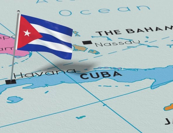 map of the island of Cuba with a Cuban flag