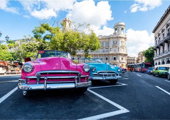 two colorful old chevys in Cuba