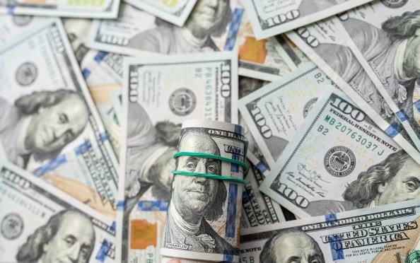 a pile of hundred USD bills